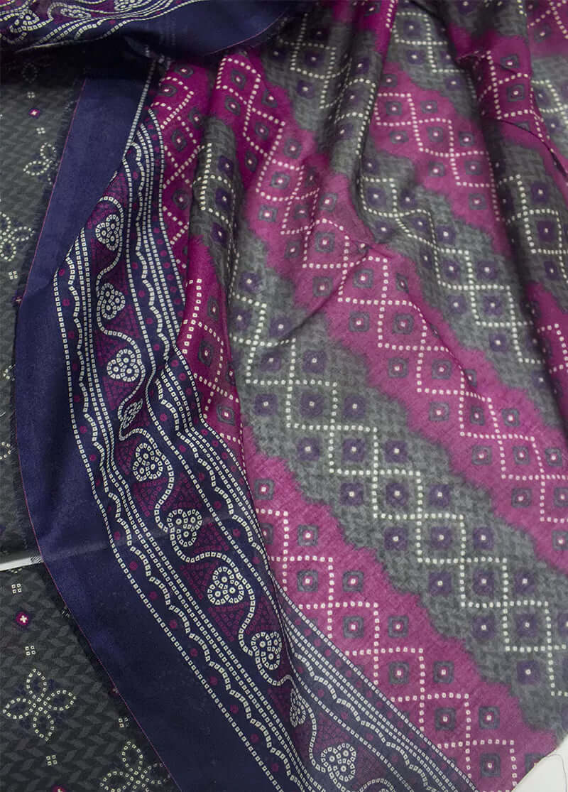 Purple and gray patterned fabric with a visible brand logo.