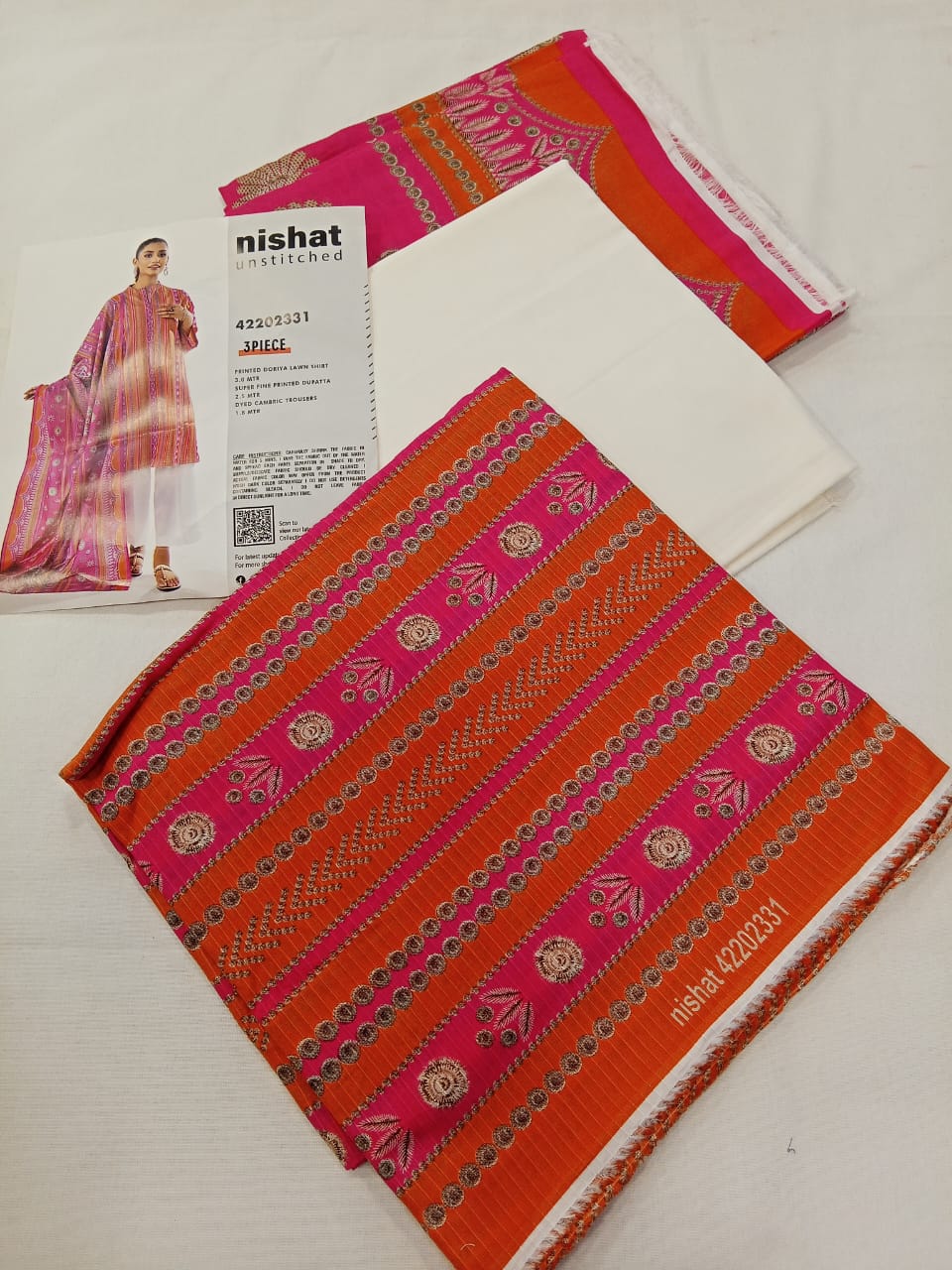 A model wearing the Nishat 3pc Unstitched Doriya Lawn Orange suit