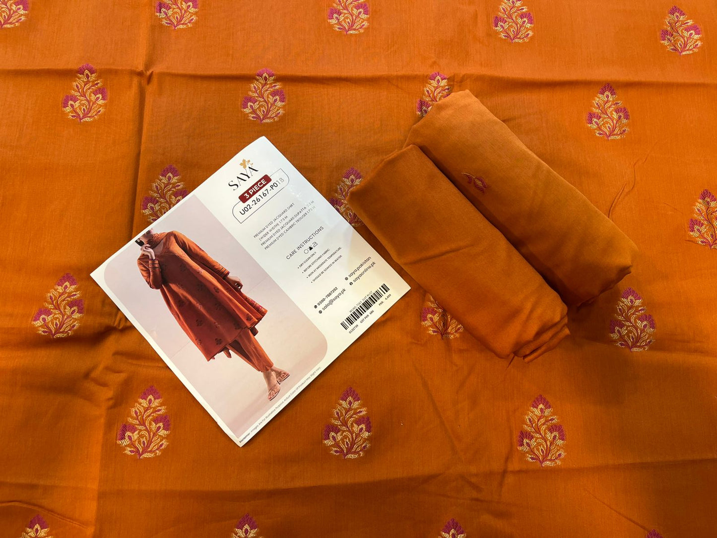 Close-up texture of Rust Saya Cotton Jacquard 3pc self-woven fabric.