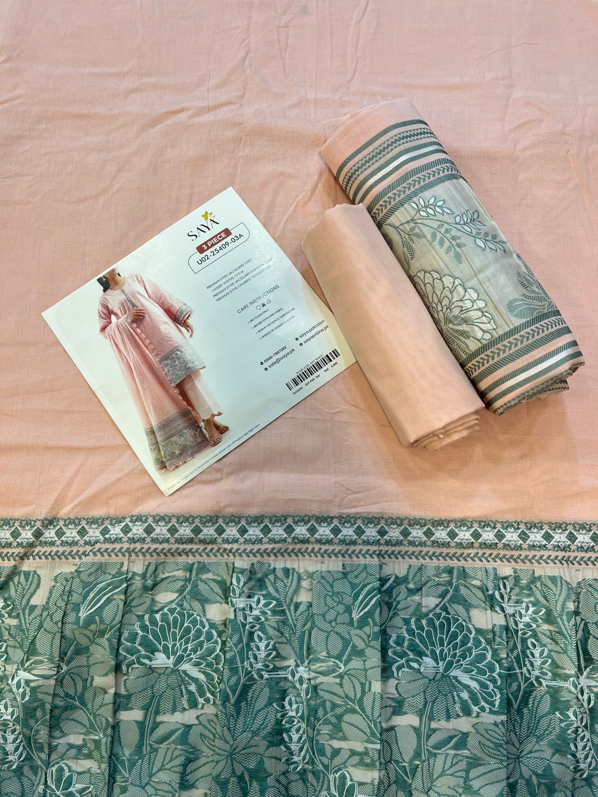 Close-up texture of Peach Saya Cotton Jacquard 3pc self-woven fabric.