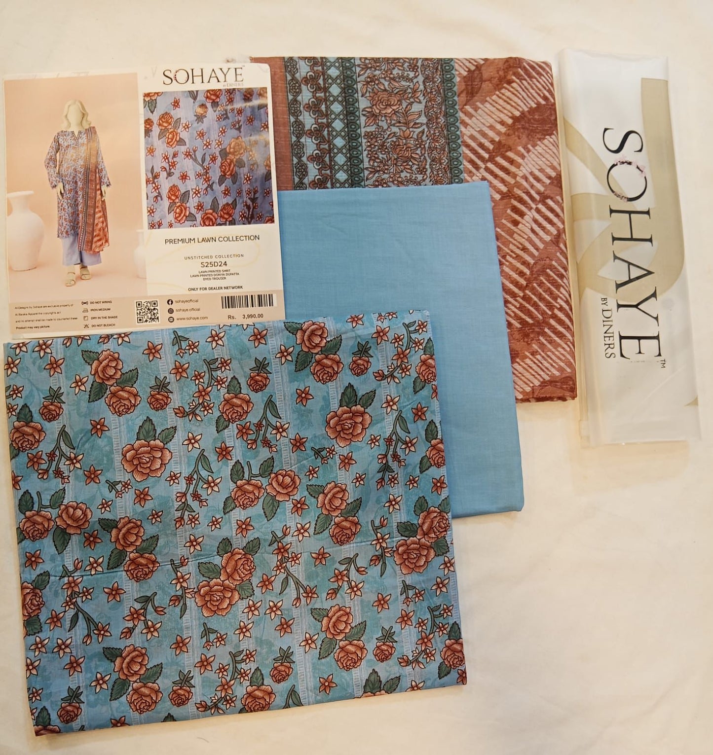 Fabric samples with floral and striped patterns and a Sohaye brand packet.