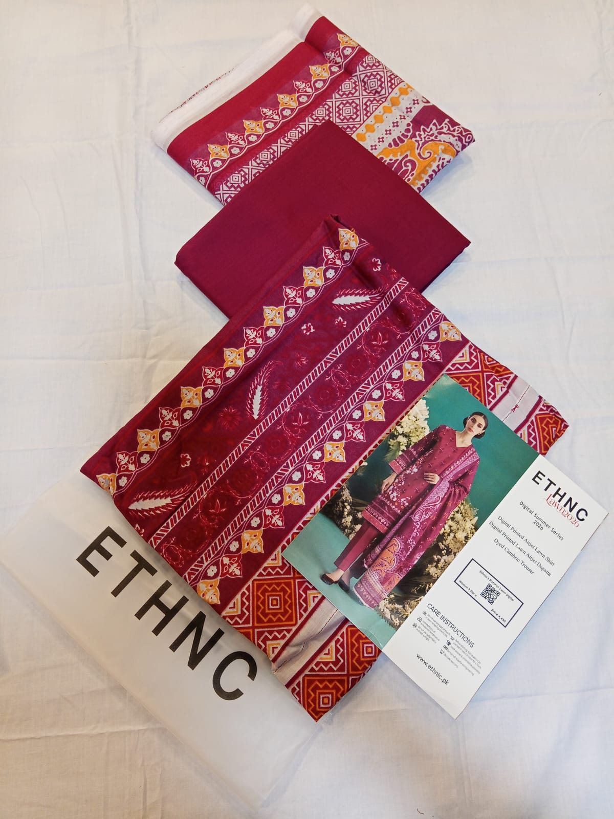 ETHNC Lawn 3pc Unstitched – Deep Berry set with digital printed shirt, dupatta, and dyed cambric trousers.