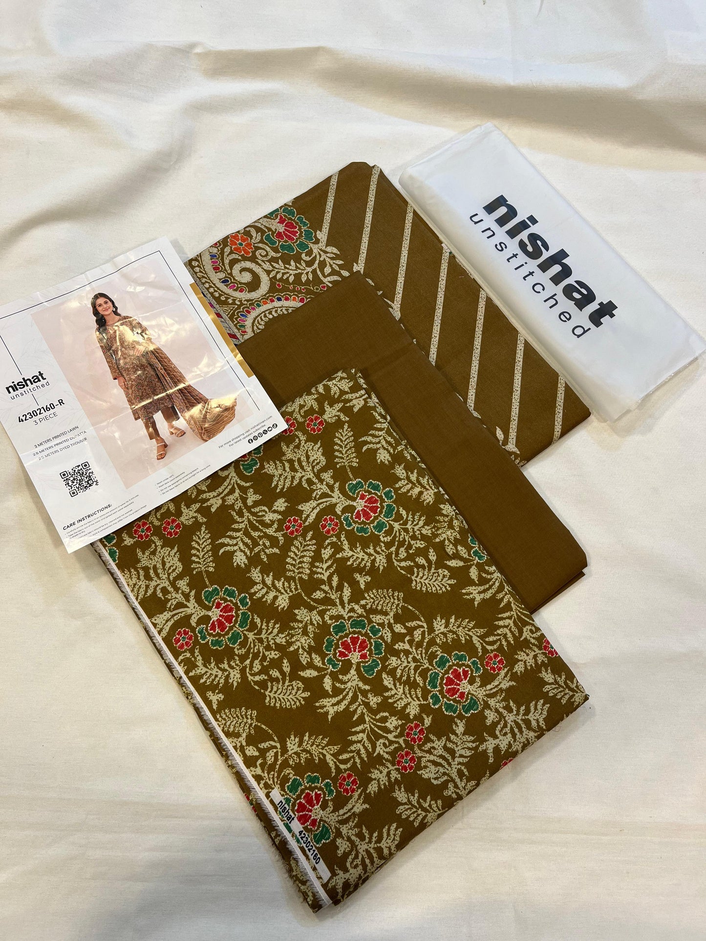 Nisha By Nishat 3pc Unstitched Lawn - Dull Olive, includes fabric pieces and a printed shirt catalog.