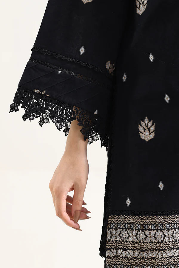 Close-up of hand with stylish lace detailing on cuff of Saya Cotton Jacquard 3pc in Black fabric.