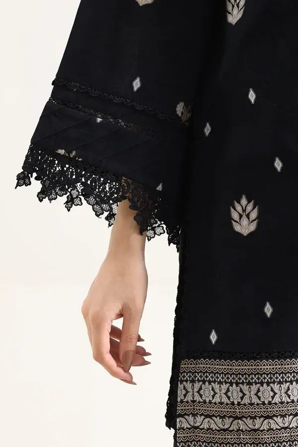 Close-up of hand with stylish lace detailing on cuff of Saya Cotton Jacquard 3pc in Black fabric.