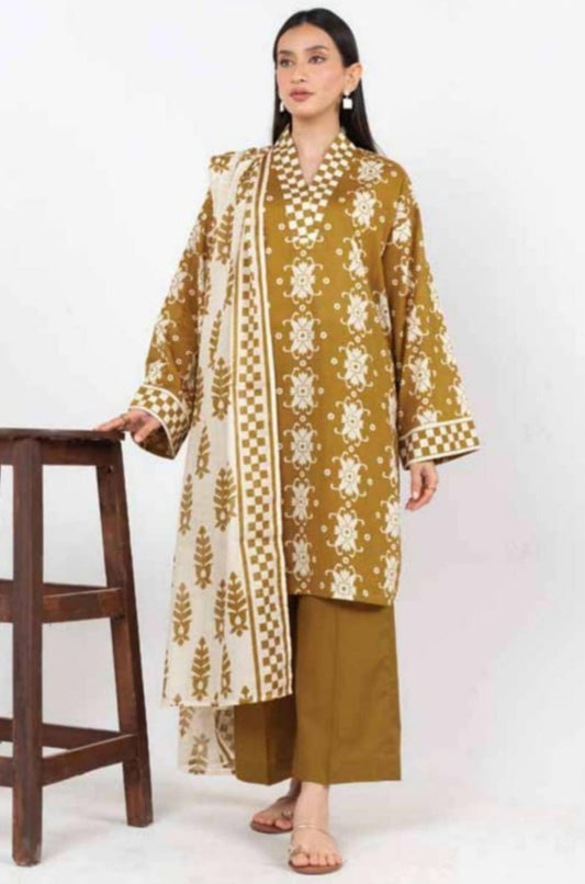 Woman wearing a mustard embroidered outfit with a stool on a white background, featuring Alkaram branding.