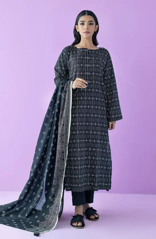 A woman modeling a black long kurta with white geometric patterns, paired with a matching black dupatta featuring white motifs, set against a solid lavender-purple studio background.