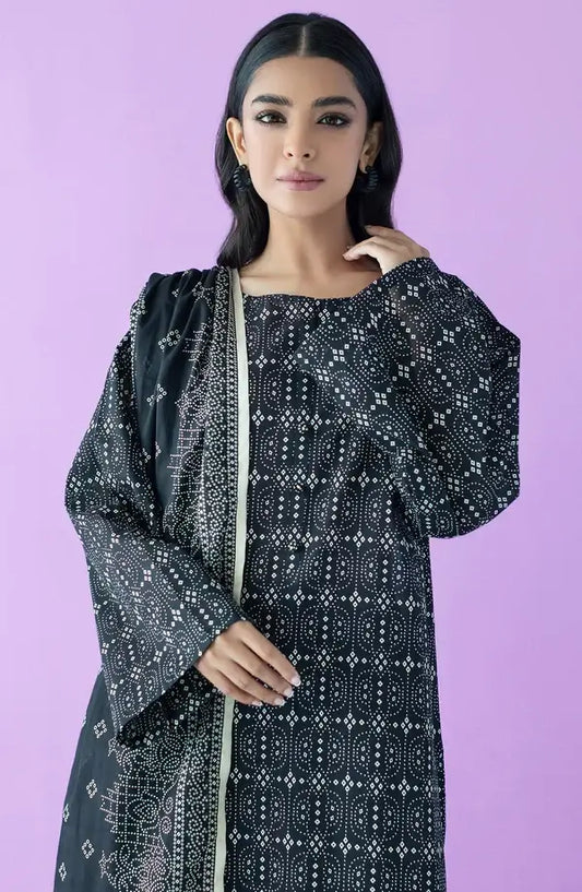 A woman modeling a black long kurta with white geometric bandhani-style prints and a matching black dupatta, set against a solid lavender-purple studio background.