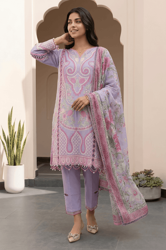 Woman wearing a light purple and pink embroidered outfit with a matching dupatta in an indoor setting.