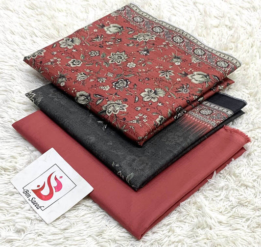 Stack of patterned fabric pieces on a textured white surface with a brand card.