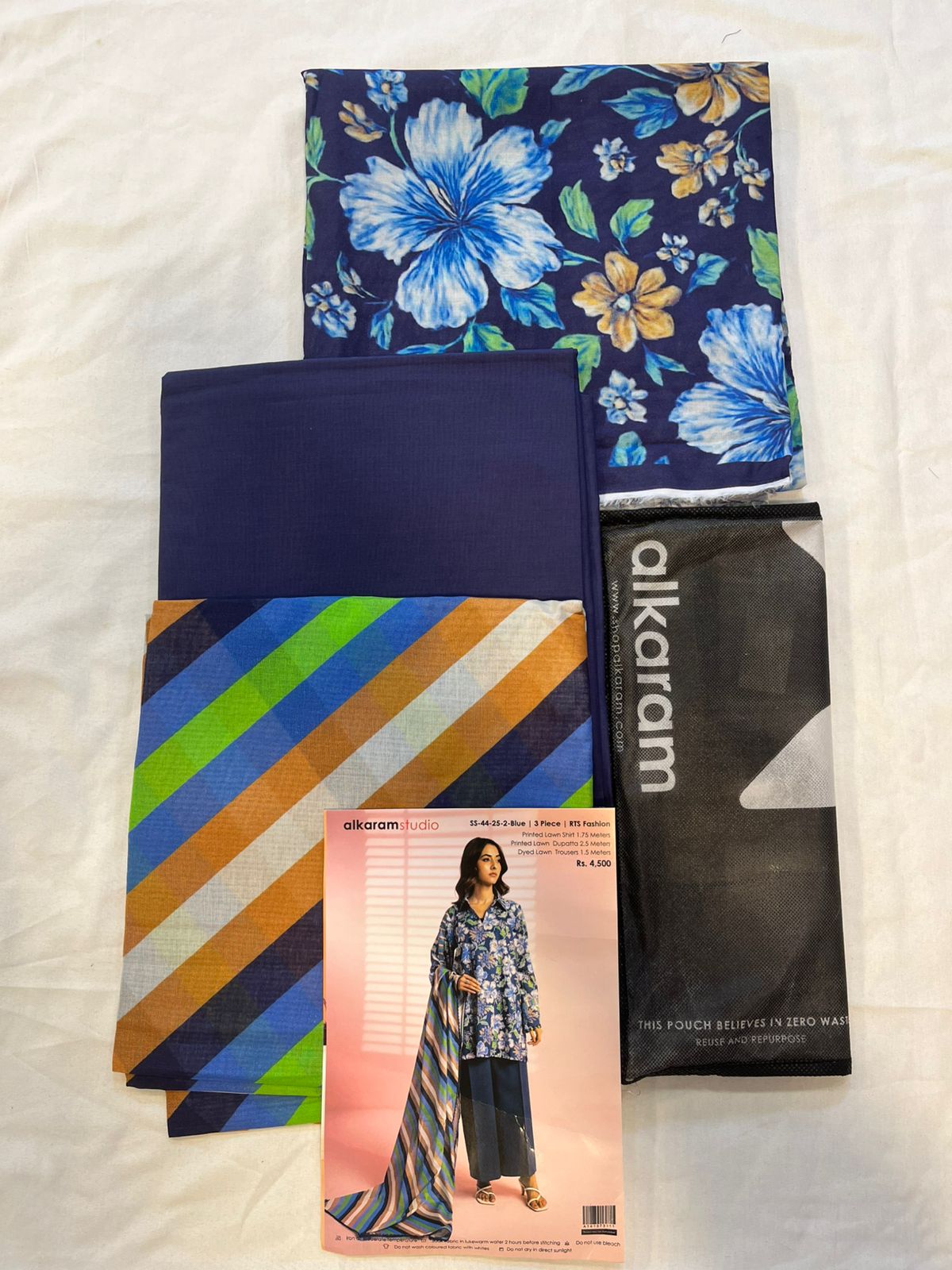 Blue - Alkaram 3pc Unstitched Lawn Suit fabric pieces including shirt, dupatta, and trousers.