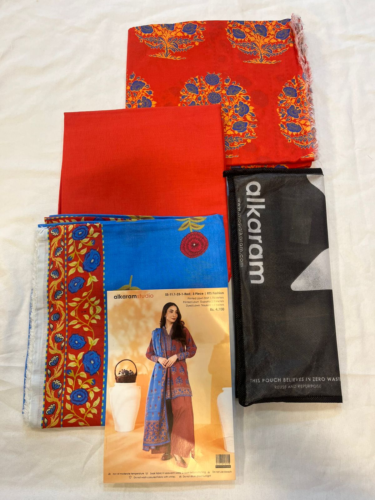 Red - Alkaram 3pc Unstitched Lawn Suit featuring printed lawn shirt, dyed cambric trousers, and dupatta.