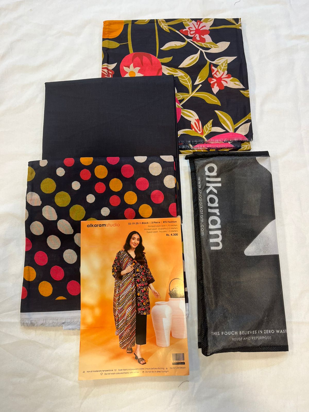Black - Alkaram 3pc Unstitched Lawn Suit fabric pieces including printed lawn shirt and dupatta.