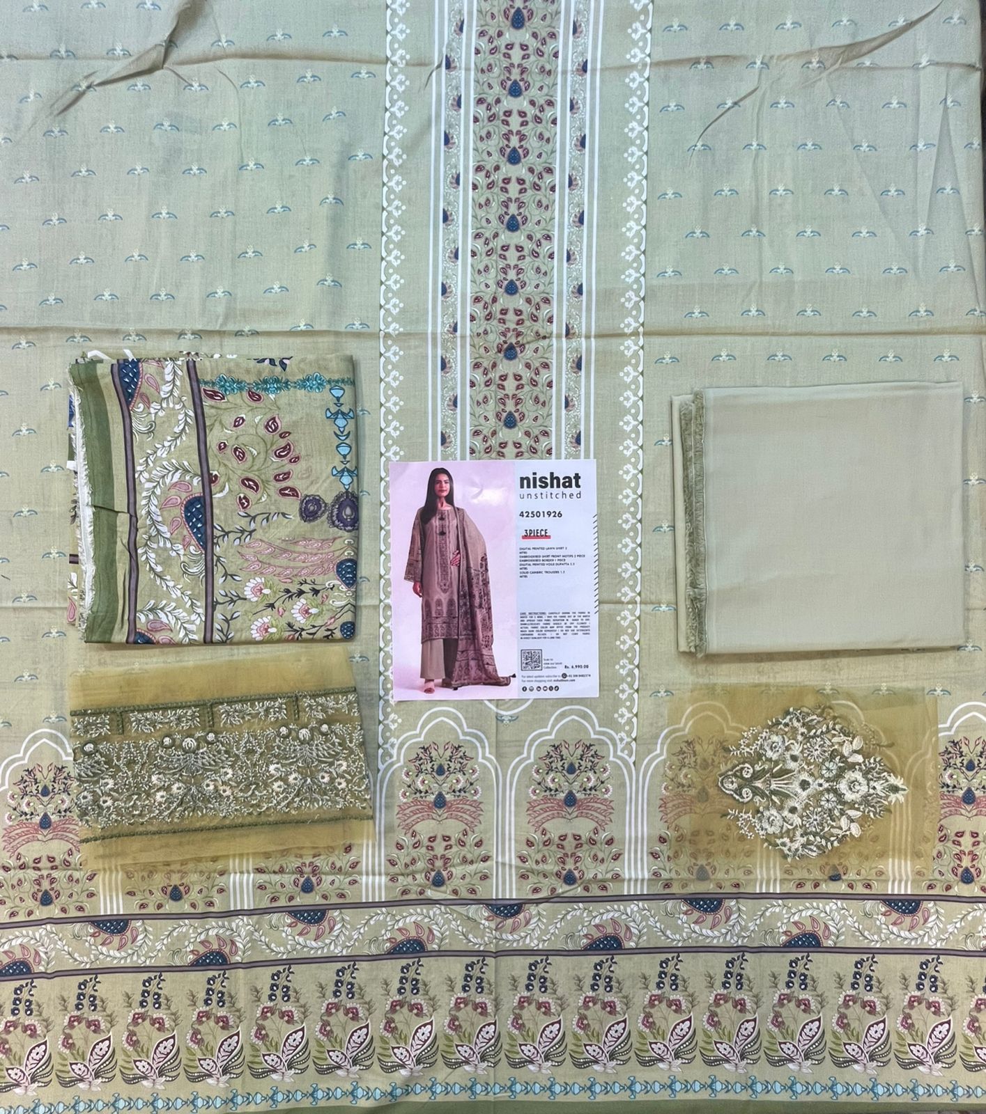 Full layout display of the shirt, dupatta, and trousers of the Nisha By Nishat Embroidered Lawn 3pc.