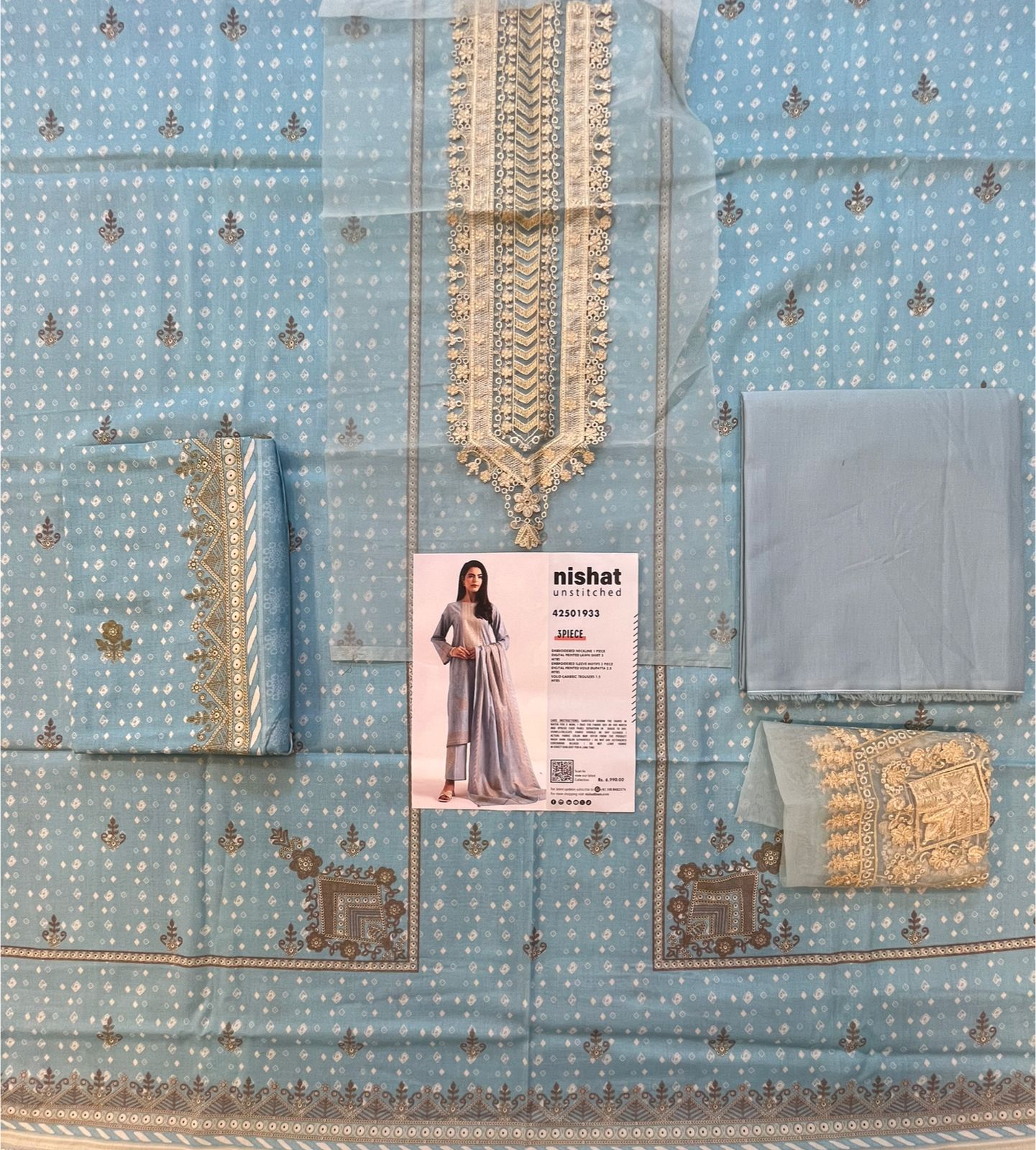 Full layout display of the shirt, dupatta, and trousers of the Nisha By Nishat Embroidered Lawn 3pc.