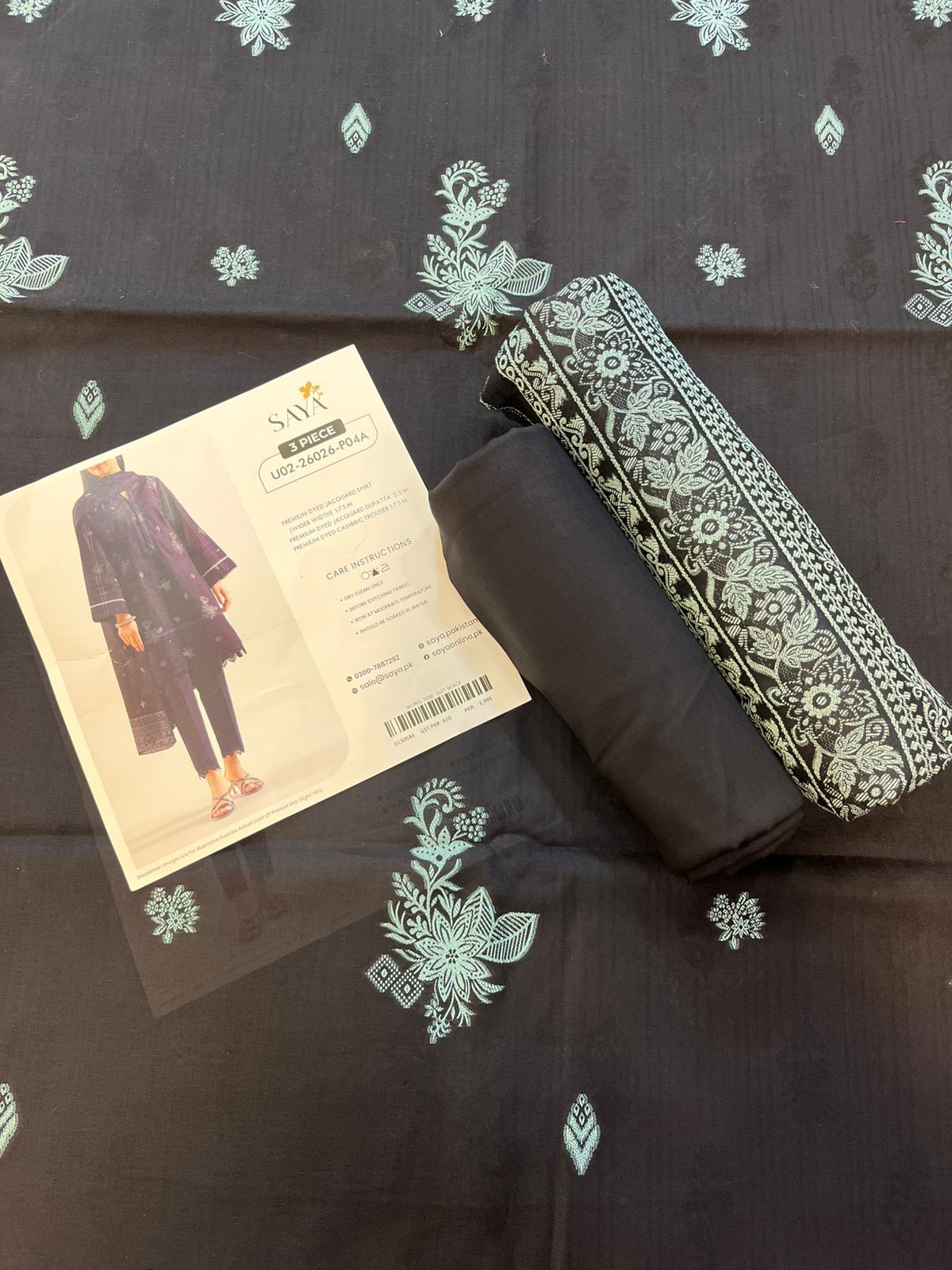 Close-up texture of Black Saya Cotton Jacquard 3pc self-woven fabric.