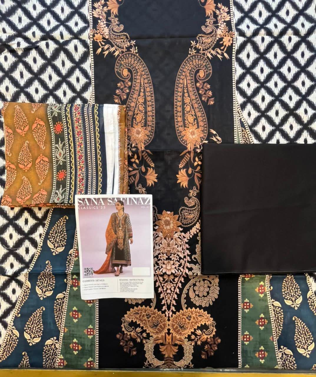 Fabric swatches with intricate patterns and a fashion magazine on a checkered background