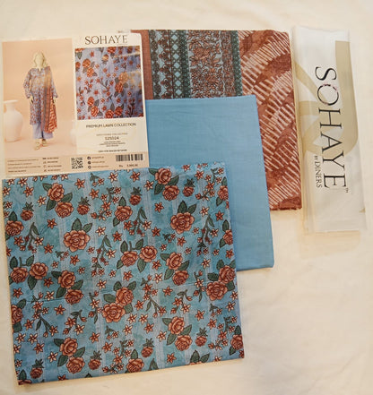 Fabric samples with floral and striped patterns and a Sohaye brand packet.