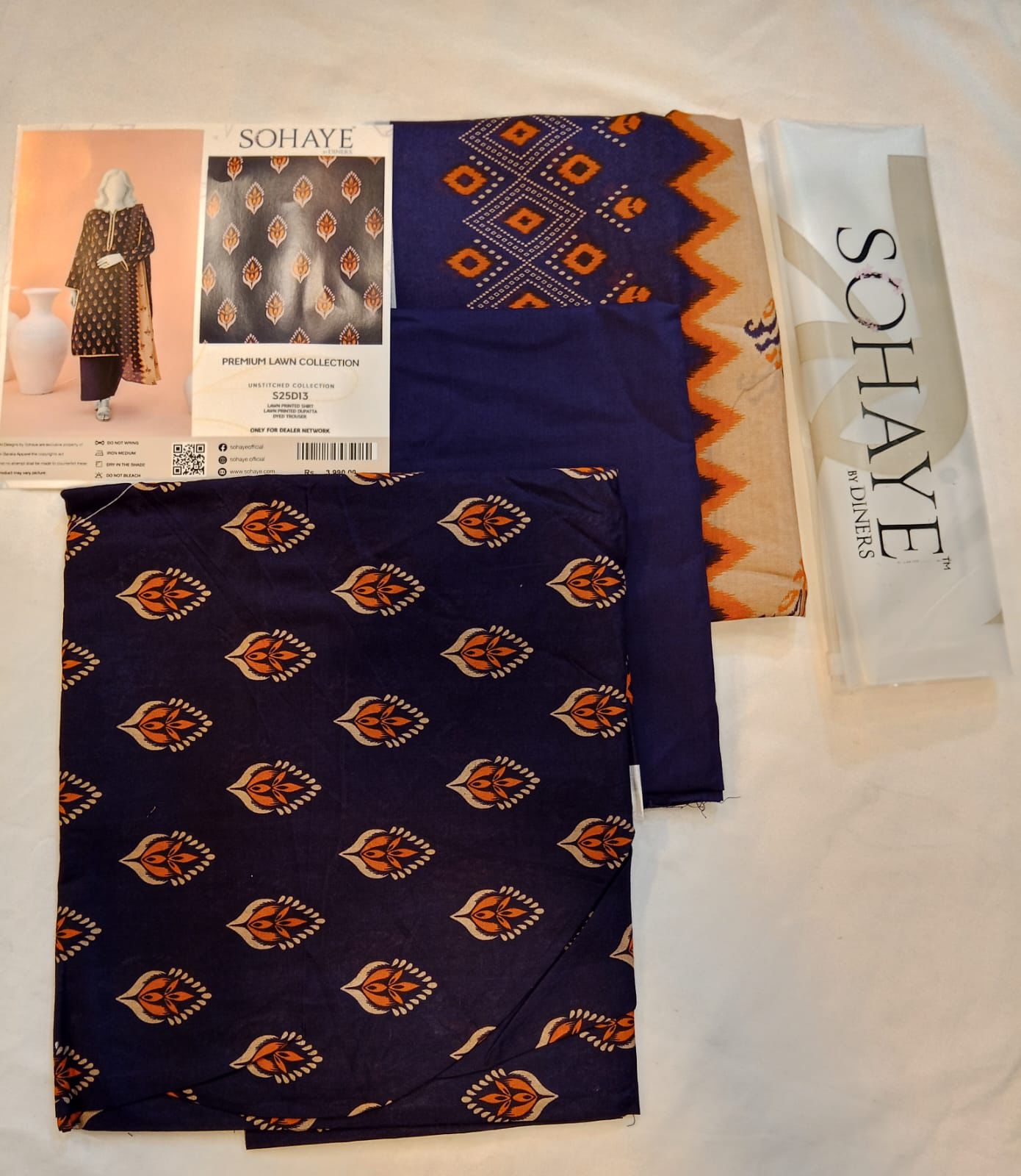 Navy fabric with orange patterns and Sohaye branding on a white background