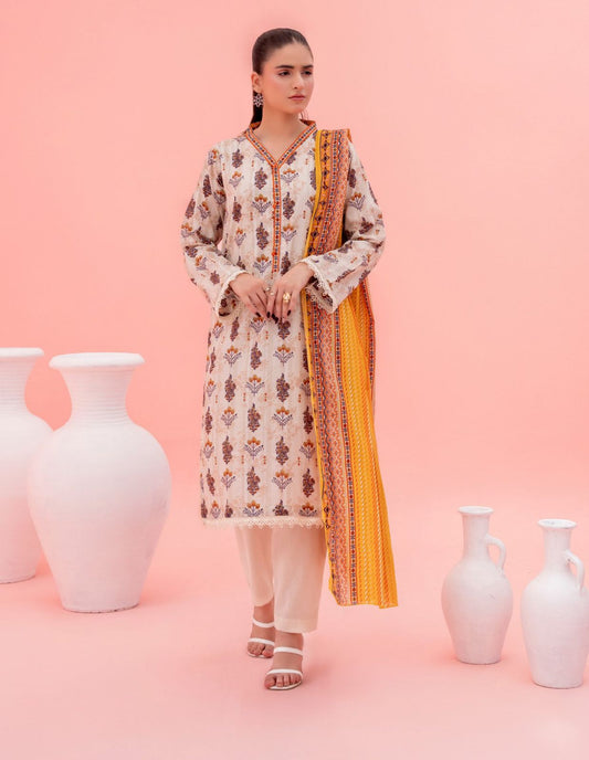 Woman in a patterned kurta with a yellow border standing between white vases on a pink background
