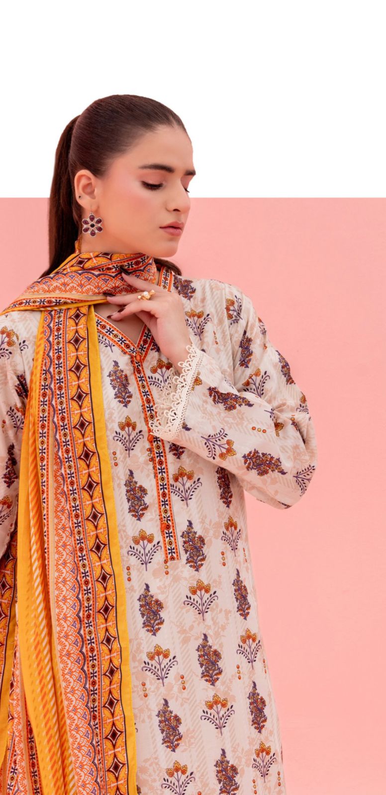 Woman wearing a patterned outfit with a pink background