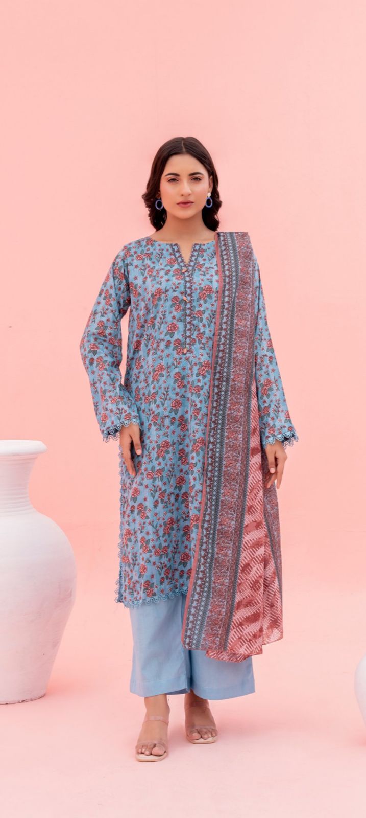 Woman wearing a floral dress with a pink background